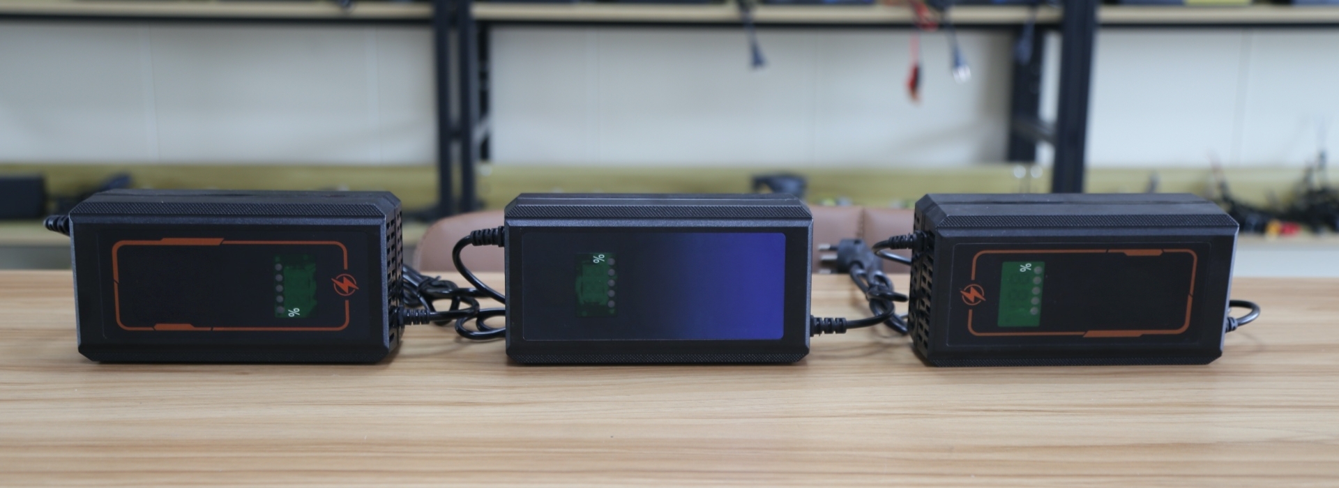 ODM battery charger manufacturer reviewing battery specifications, charger PCB, prototype and test equipment before approval.