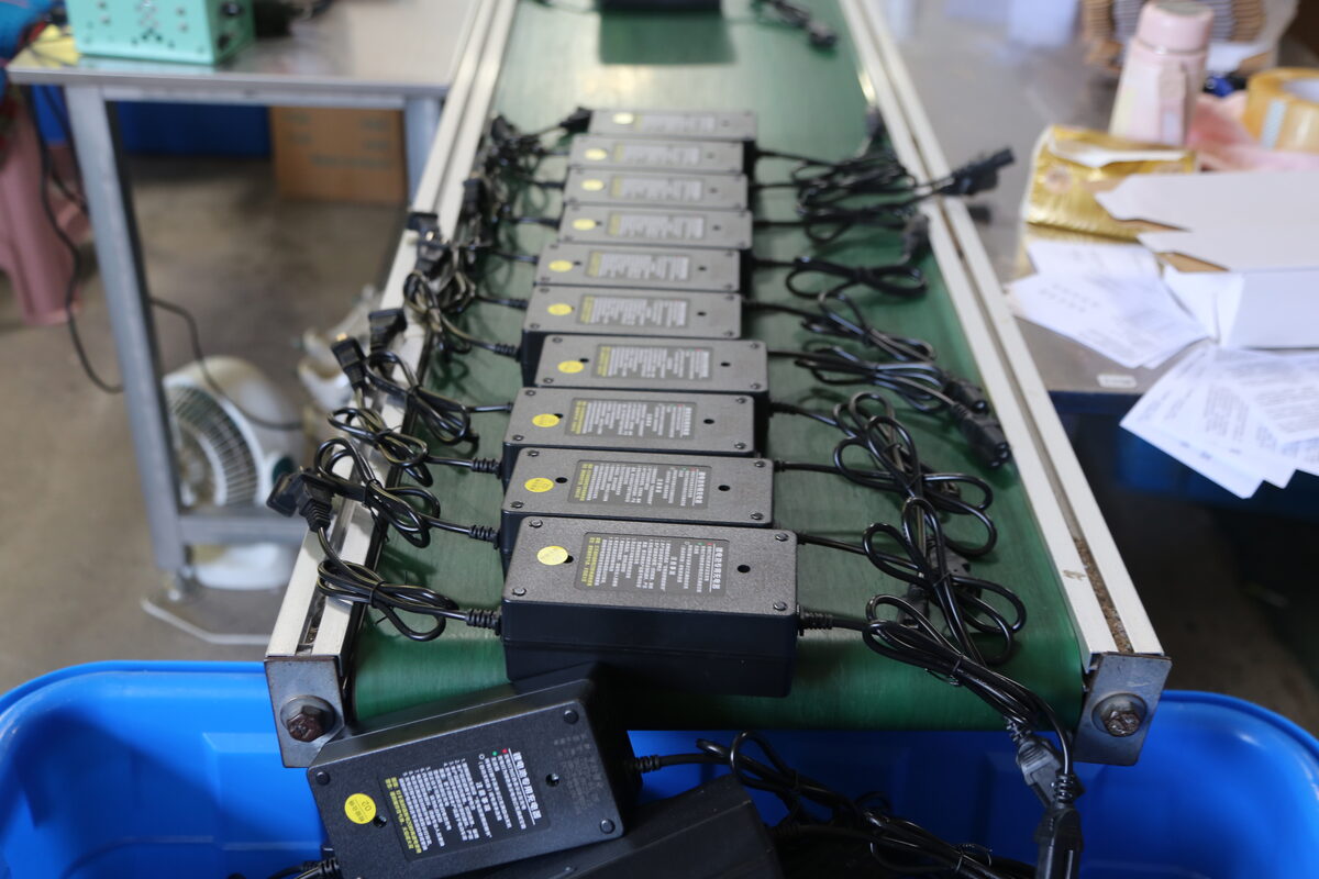 Multiple battery chargers connected for batch electrical checks after the 48V current specification is approved.