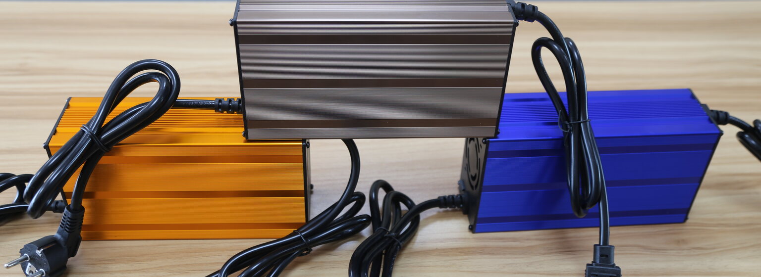 Different Linjia charger housings illustrating why nominal 48V alone does not define battery-chemistry compatibility.