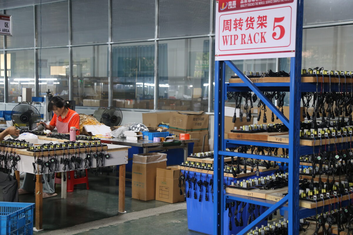 Battery charger production area with identified work-in-process racks for chemistry-specific configuration control.