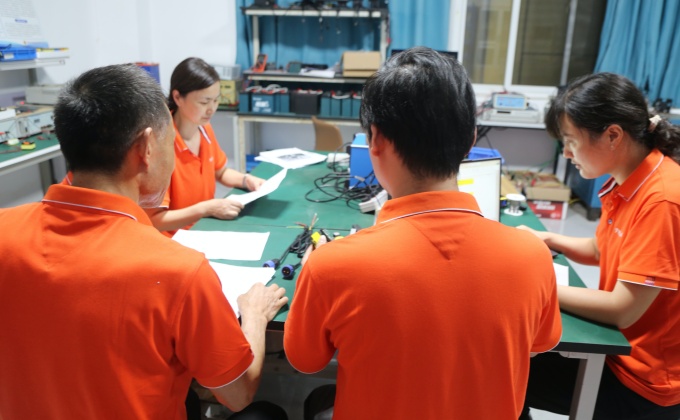 Battery charger engineering team reviewing battery, BMS, voltage, current and connector requirements for OEM projects.