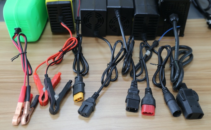 Battery charger output connector options including plugs and battery clamps
