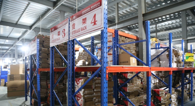 Packaging materials organized on storage racks for battery charger orders
