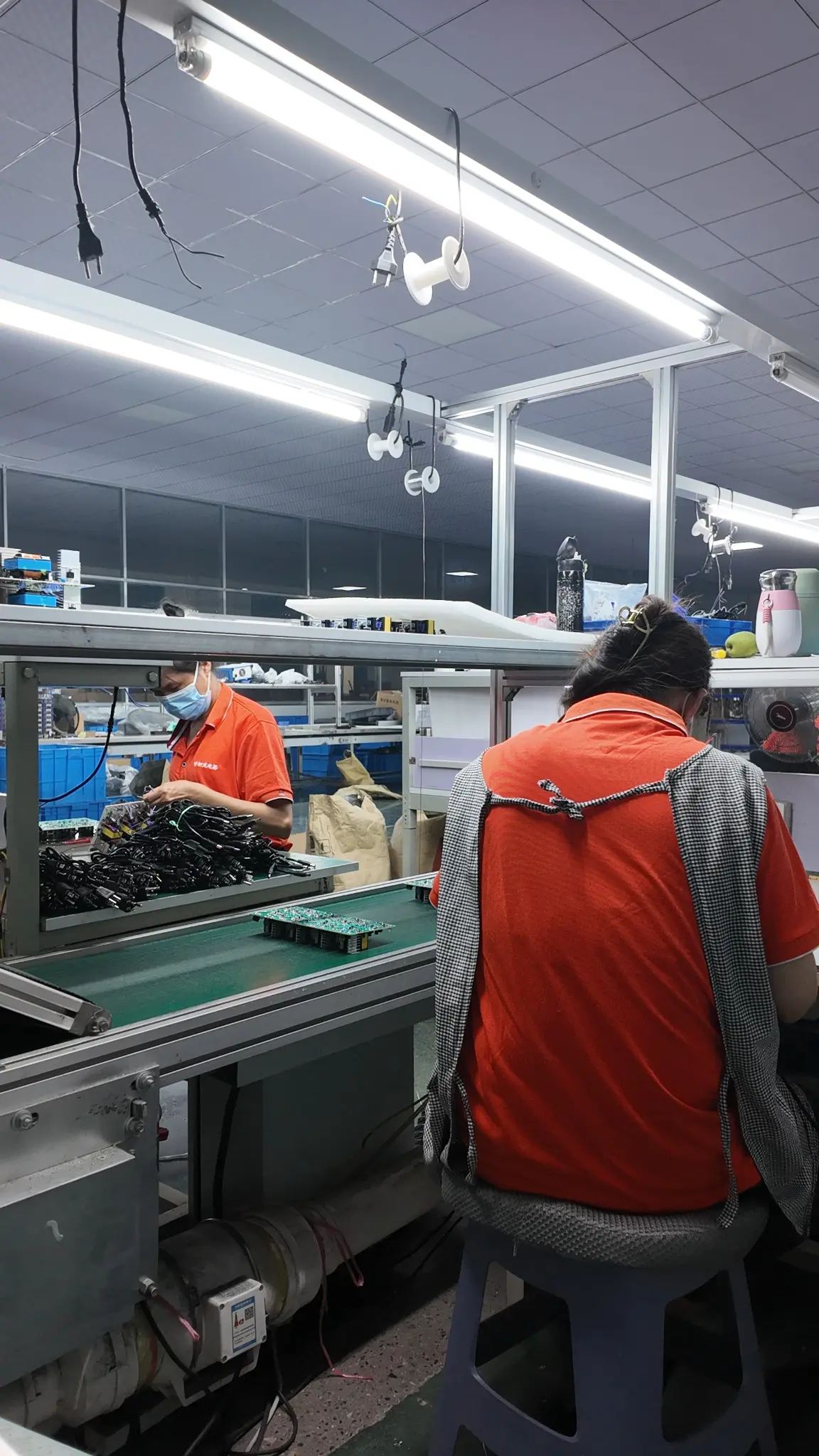 Linjia production team assembling and checking battery charger components against approved OEM specifications.