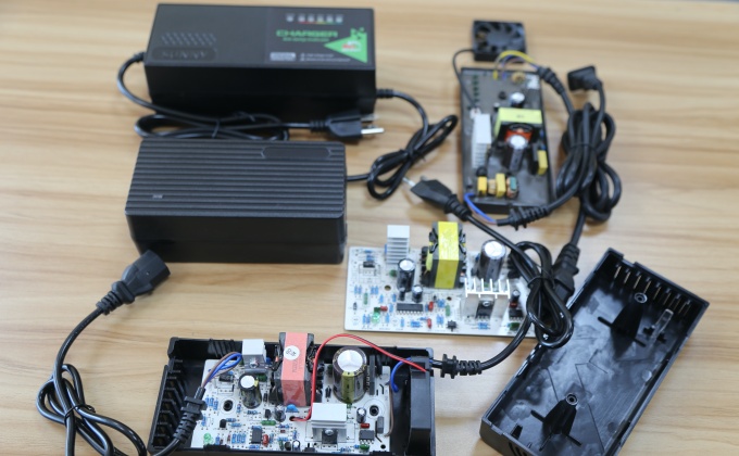 Open battery chargers showing PCBA, wiring and housing configurations for OEM projects

