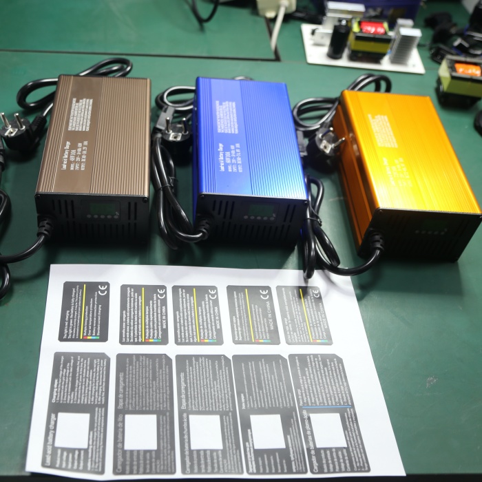 OEM battery charger with project-specific housing colours, labels and packaging prepared for different order configurations. 