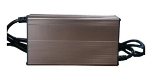 Ribbed aluminum battery charger housing with black end caps and cables on a white background.