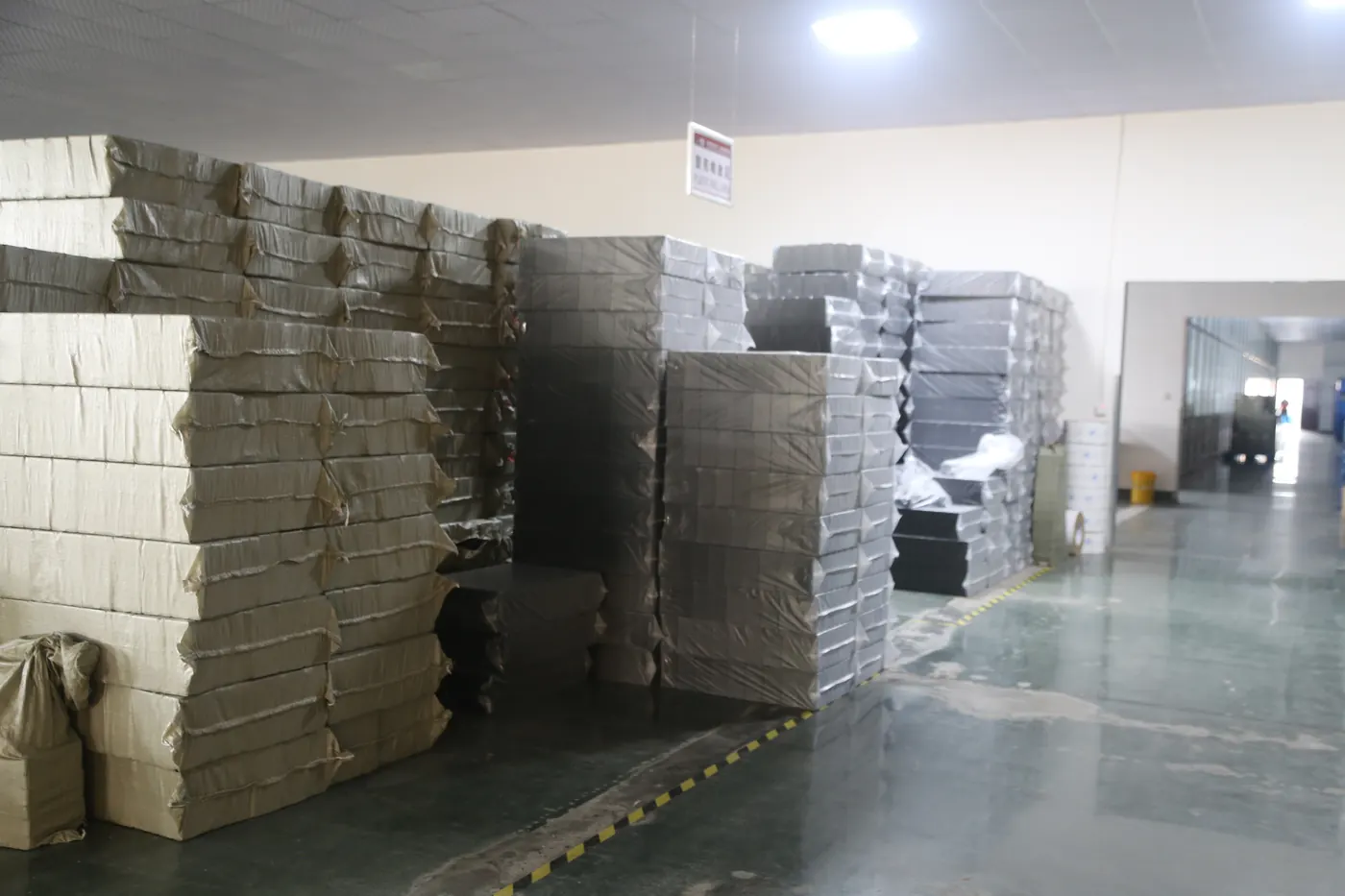 Stacks of packed battery chargers in the Linjia factory storage area.